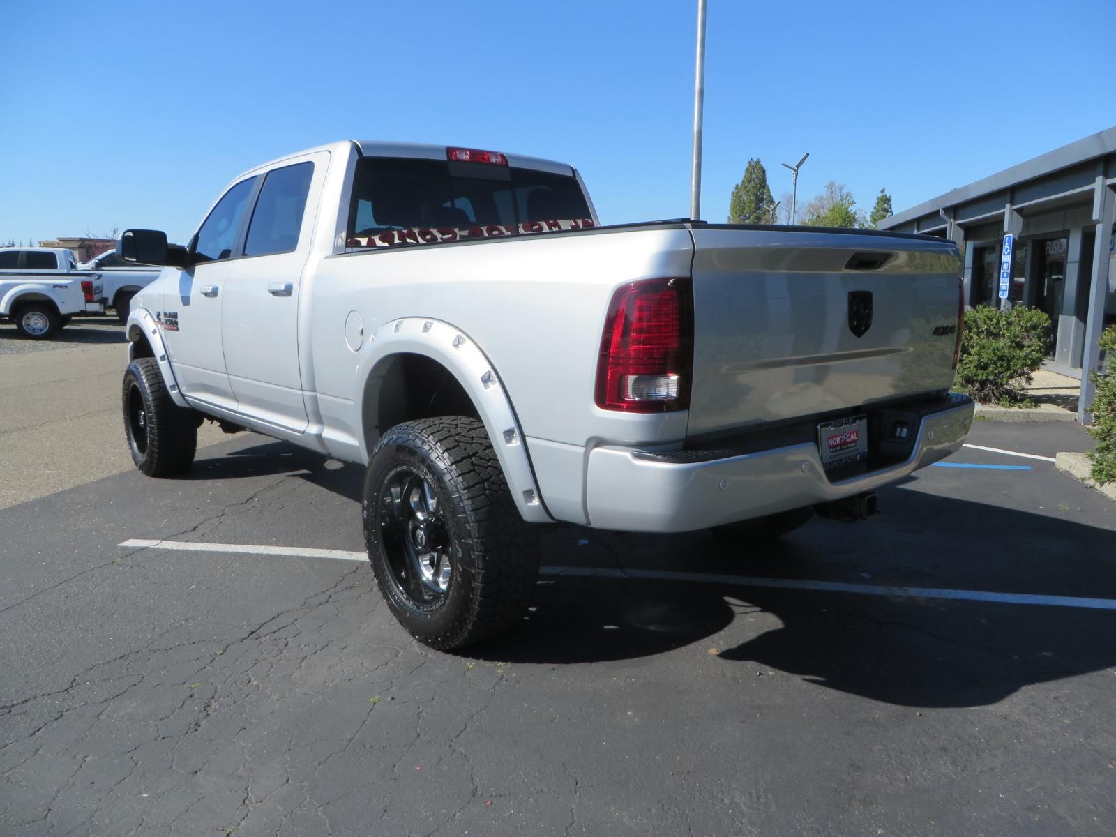 2016 SILVER /BLACK RAM 2500 Laramie Crew Cab SWB 4WD (3C6UR5FL3GG) with an 6.7L L6 OHV 24V TURBO DIESEL engine, 6A transmission, located at 2630 Grass Valley Highway, Auburn, CA, 95603, (530) 508-5100, 38.937893, -121.095482 - Leveled Ram sitting on Fuel Offroad wheels, Falken Wildpeak AT tires, Amp Power steps, Rolling Bed cover, Color matched fender flares, and window tint. - Photo #6